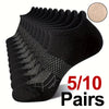 A stack of black performance compression ankle socks with a gold glitter swatch shown next to the product.