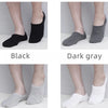 A display of men's invisible silicone no-show socks in black, dark gray, light gray, and white.