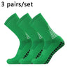 Three pairs of green performance football socks displayed together.