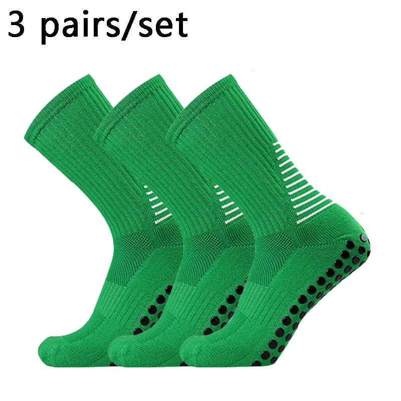 Three pairs of green performance football socks displayed together.