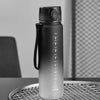 A matte gray sports water bottle with a black cap and strap is displayed on a wire rack.