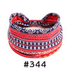 A close-up of a red and blue patterned boho knotted cotton headband.