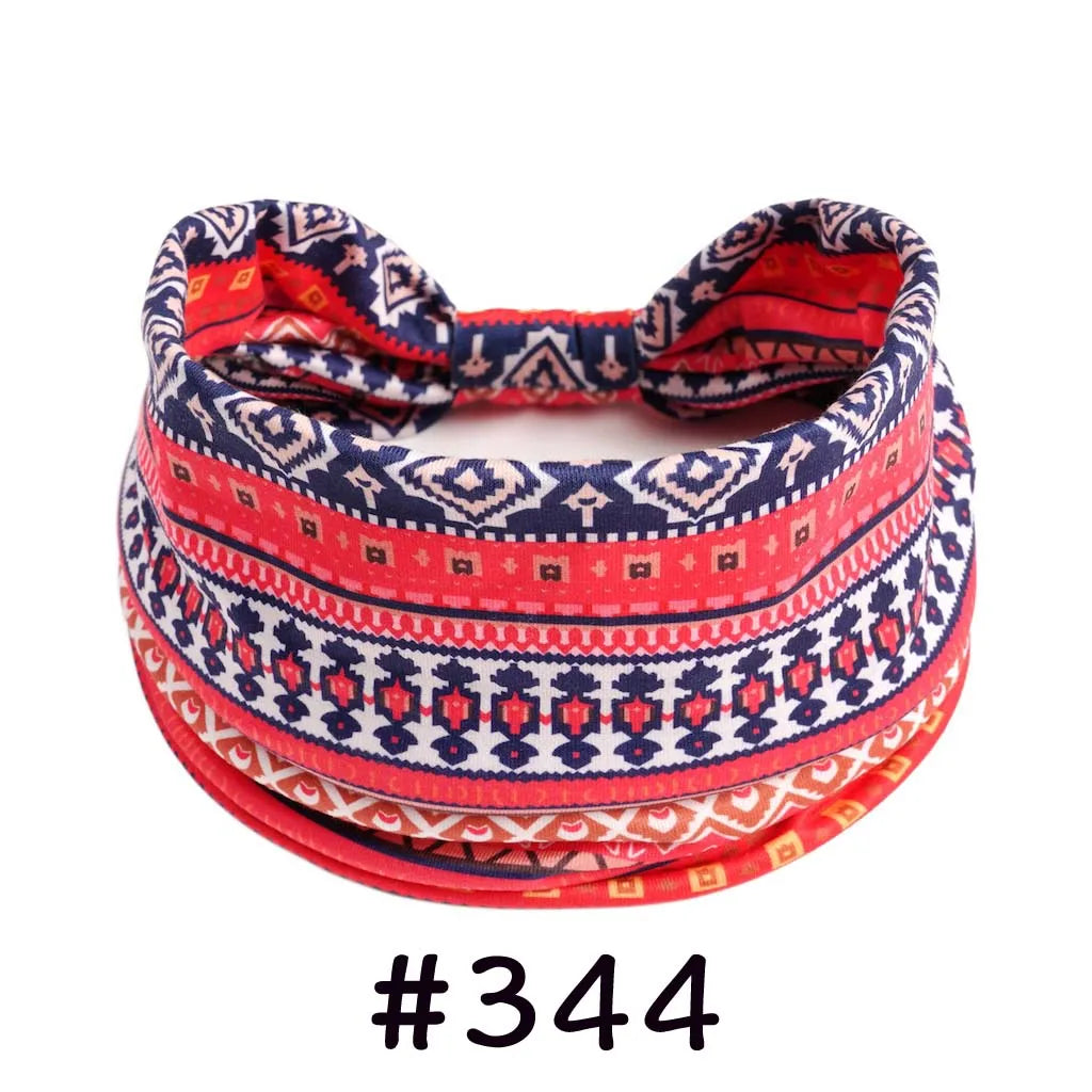 A close-up of a red and blue patterned boho knotted cotton headband.