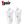 A pair of white premium breathable men's running socks shown flat.