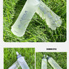 Clear silicone water bottles lying on green grass with a focus on their design and texture.