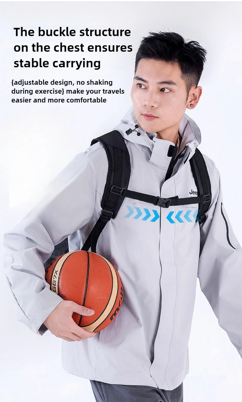 A young man wearing a light gray jacket with a buckle structure on the chest carrying an orange basketball.
