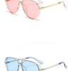 Pair of classic oval pilot sunglasses with pink and blue lenses and gold-toned metal frames
