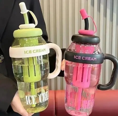 A clear reusable water bottle with a straw and handle, featuring ice cream themed colors like lime green and pink.