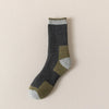 A pair of merino wool thermal hiking socks in shades of gray, olive green, and beige.