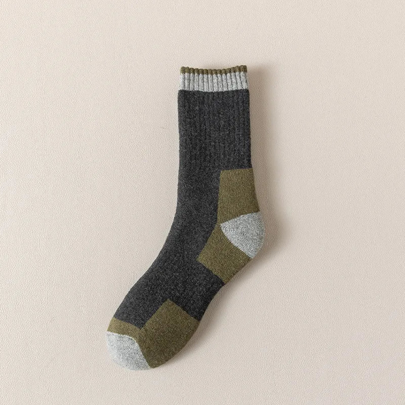 A pair of merino wool thermal hiking socks in shades of gray, olive green, and beige.