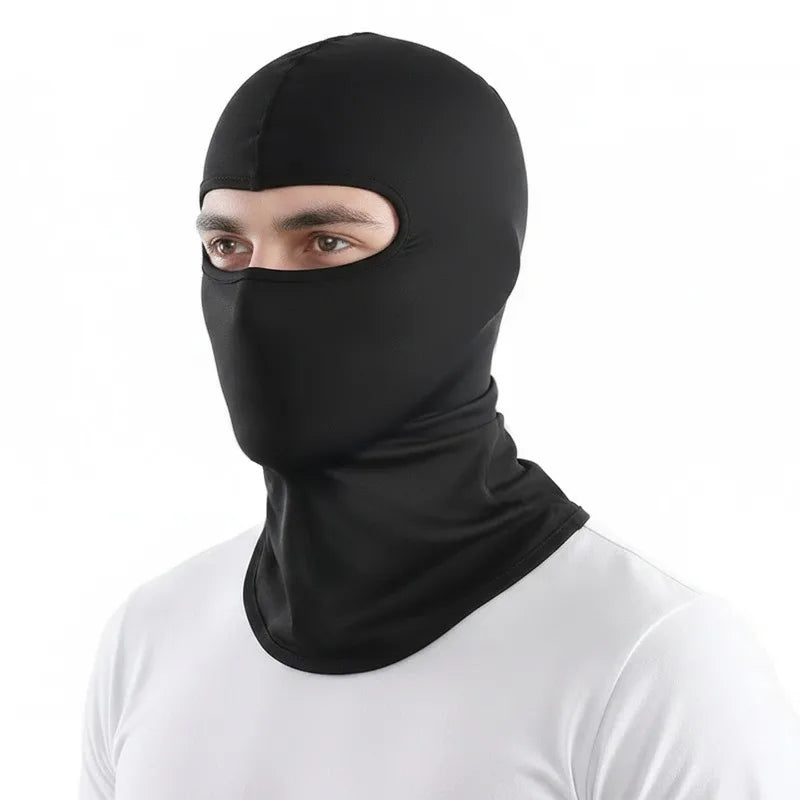 A man wearing a black all-in-one thermal balaclava and head covering.