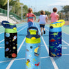 A trio of colorful insulated stainless steel thermos cups with various cartoon patterns resting on a blue running track.