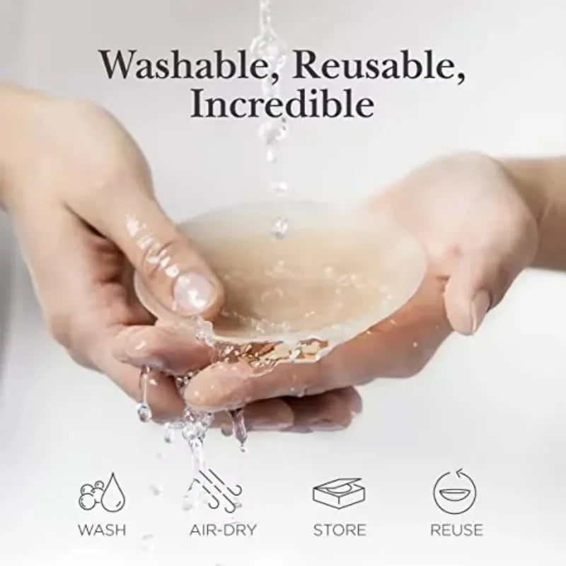 Des mains tiennent une coque de sein en silicone translucide qui goutte de l'eau, démontrant ses caractéristiques lavables et