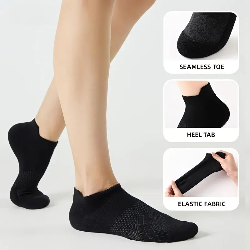 Black performance compression ankle socks shown on a leg, highlighting seamless toe, heel tab, and elastic fabric.