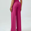 A woman is modeling high waisted magenta yoga pants with a light top.