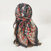 Elegant satin square scarf featuring a floral pattern in black, red, and cream tones