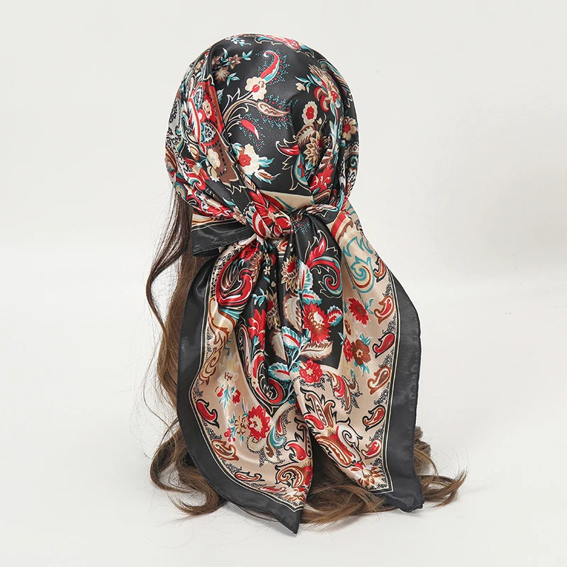 Elegant satin square scarf featuring a floral pattern in black, red, and cream tones