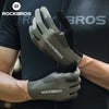 A close-up of a pair of olive green cycling performance gloves being held by a person.