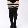 Black striped thigh high leg warmers worn on a person's leg.