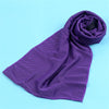 A purple microfiber cooling towel is rolled up on a light blue background.