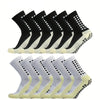 A row of multi-sport silicone grip socks for men in black and light yellow colors.