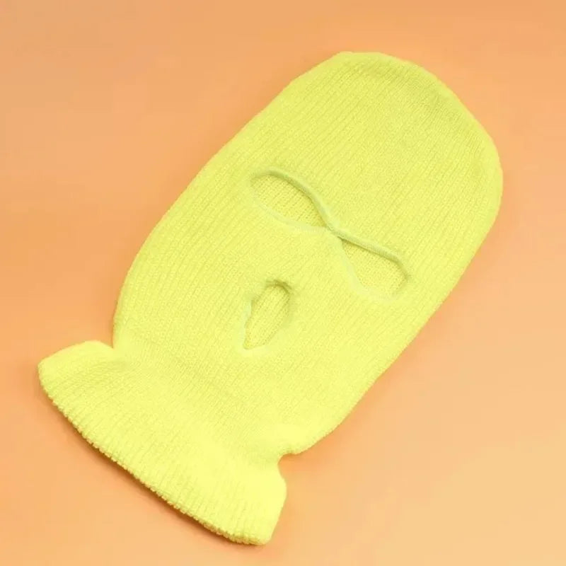 A bright yellow tactical knit balaclava beanie hat shown from above on a plain background.