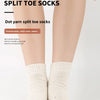 Close-up of a model wearing white split toe socks with colorful accents.