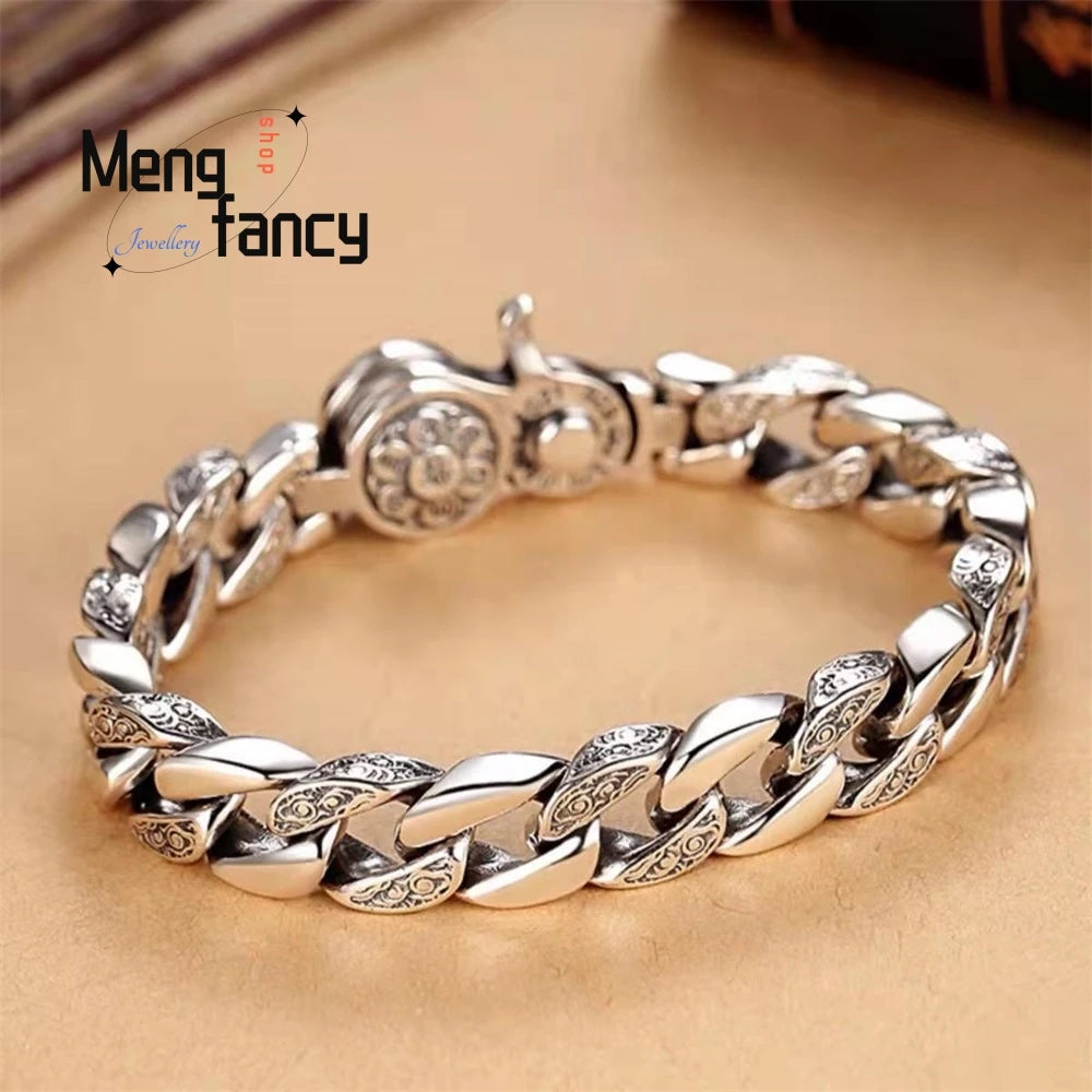 A silver mantra charm bracelet featuring interlocking links and a decorative charm on a light brown background.
