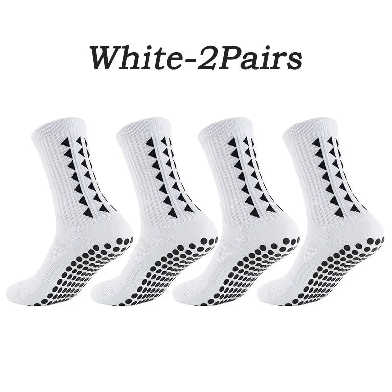 A pair of white multi-sport athletic grip socks shown flat.