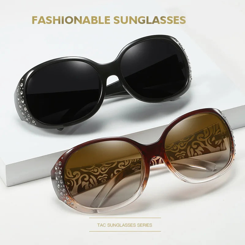 A pair of brown tinted sunglasses with diamond-inlaid detailing is displayed on a white surface.