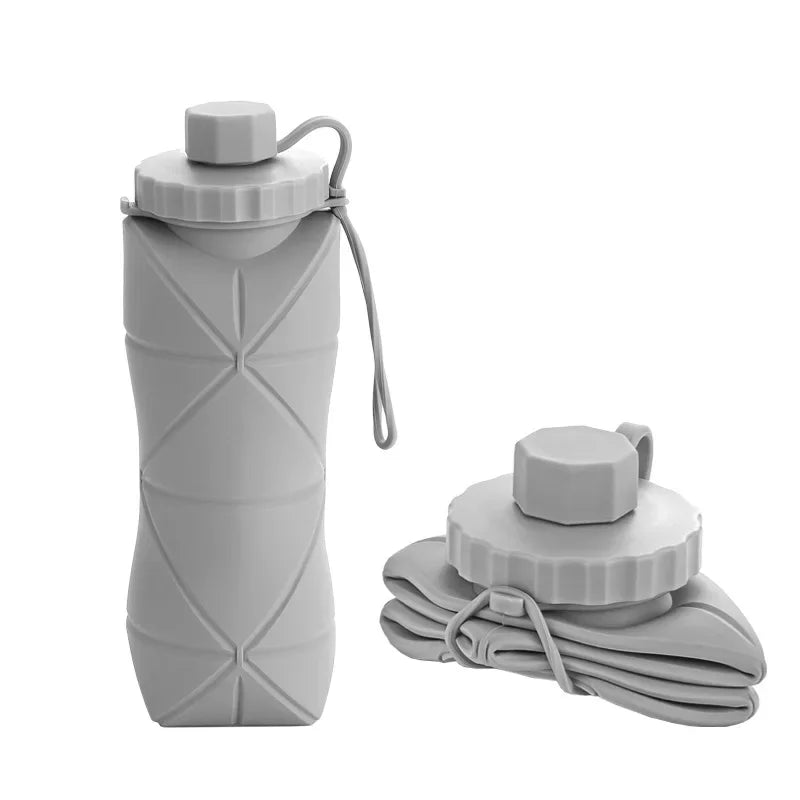 A gray silicone folding water bottle with a screw cap is shown standing upright and a stack of folded bottles.