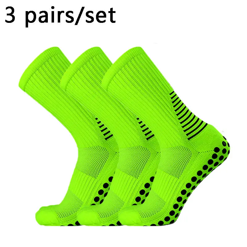 Three pairs of neon yellow performance football socks displayed together.