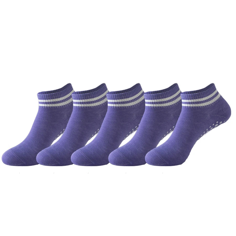 A row of purple non-slip grip socks for yoga and pilates