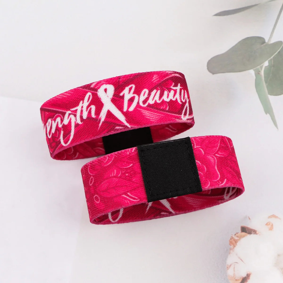 A vibrant pink stretch silicone wristband bracelet featuring a delicate floral pattern and the text Beauty.