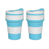 A pair of reusable silicone collapsible coffee cups with lids in white and light blue.