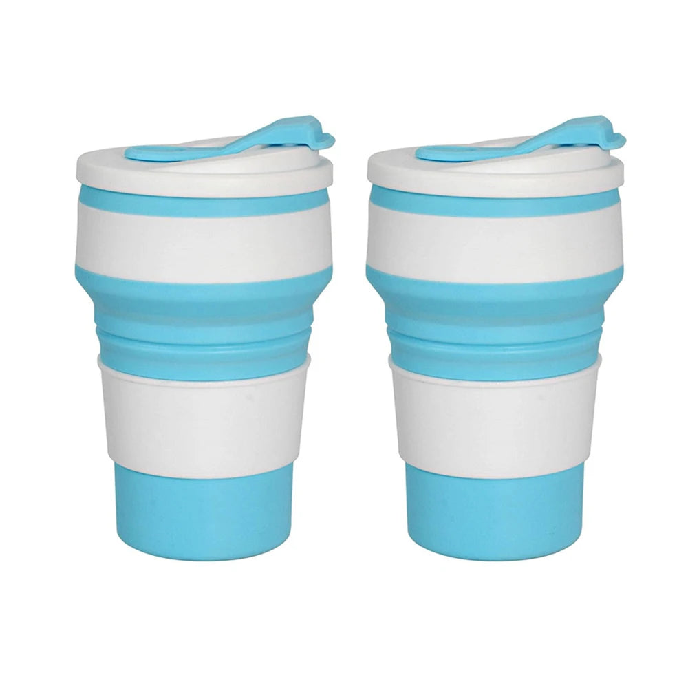 A pair of reusable silicone collapsible coffee cups with lids in white and light blue.