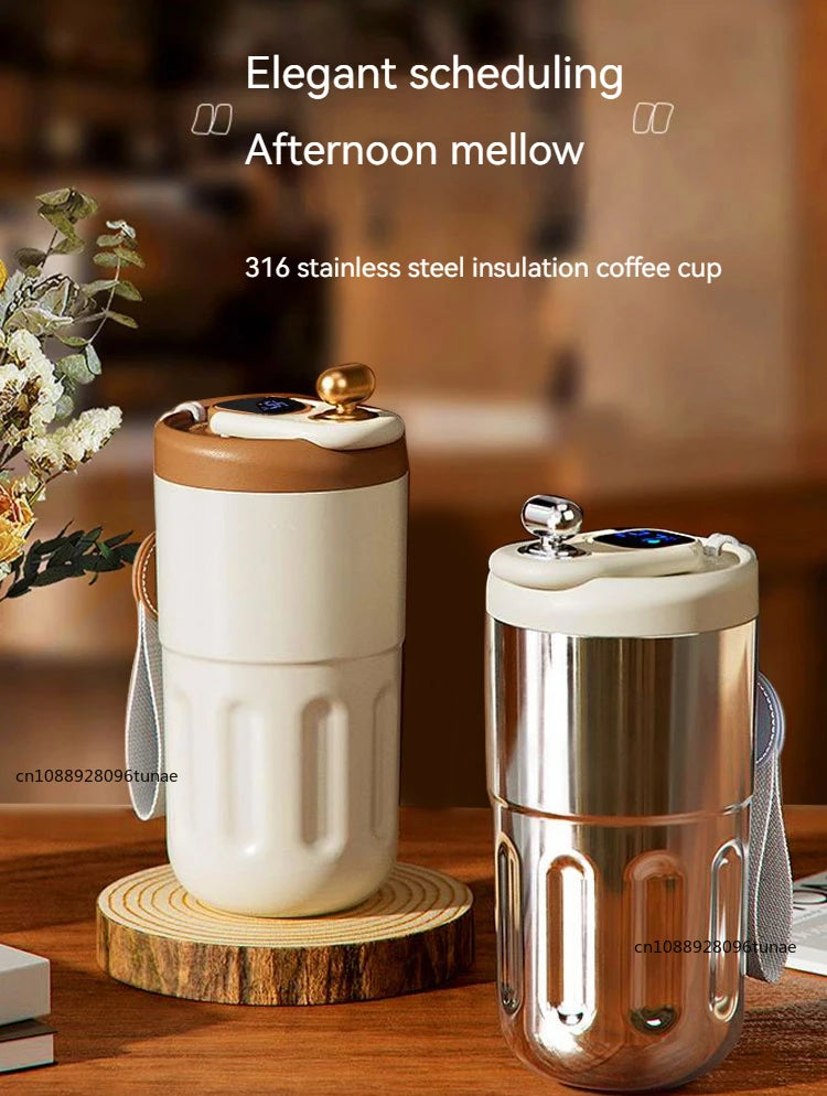 A stainless steel insulation coffee cup with a white lid and gold accent, shown on a wooden surface.
