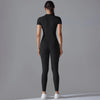 A woman is shown from the back wearing a black Naked Zipper Yoga Jumpsuit.
