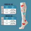 A pair of white athletic knee-high compression socks with red and blue accents, shown next to size charts.