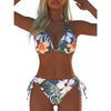 A model wearing a floral print two-piece bikini swimsuit with lace-up details.