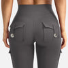 A close-up view of high-waisted gray fitness pants with multiple pockets and a ribbed top visible above.