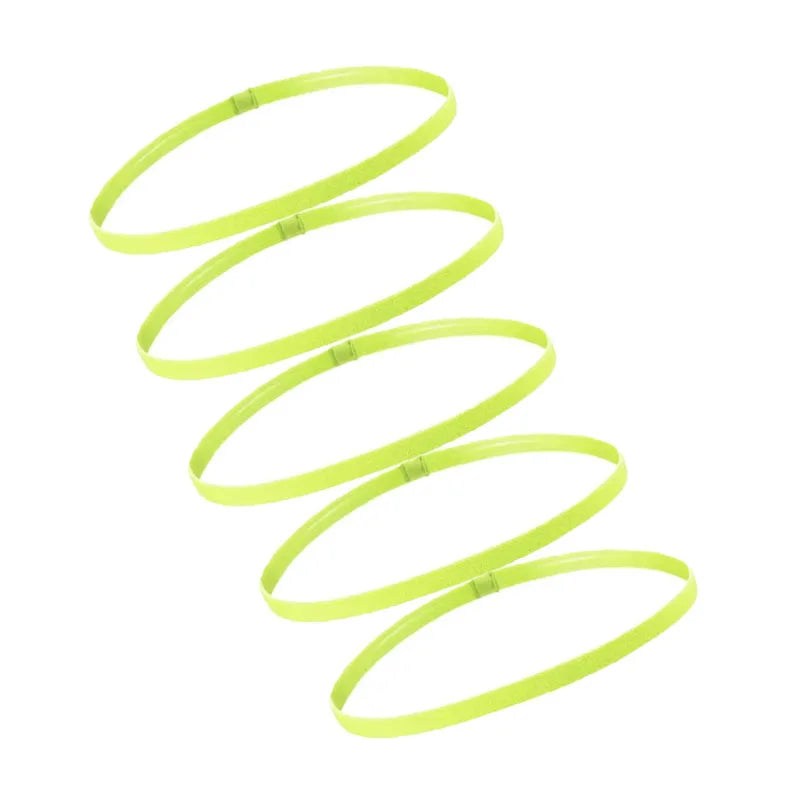 A set of five bright neon yellow elastic sports headbands coiled in a spiral formation.