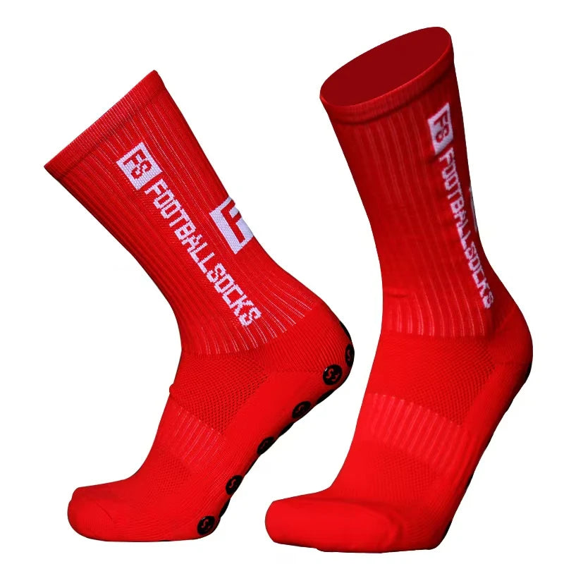 A pair of red football socks with silicone grip for anti-slip performance.