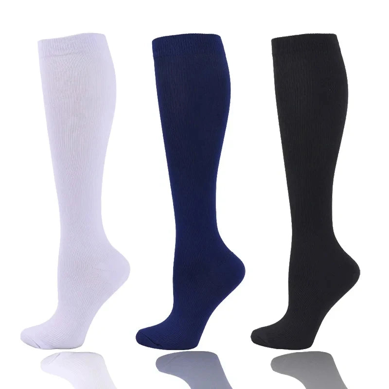 Three pairs of compression socks in white, navy blue, and black displayed vertically.