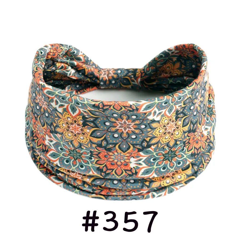 A patterned, knitted cotton headband featuring earthy tones of orange, teal, and cream.