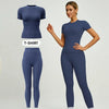 Model in navy blue sports suit, consisting of a t-shirt and matching pants.