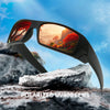 A pair of black polarized UV400 sunglasses resting on a rock with a scenic sunset view.