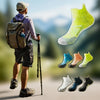 A person wearing running socks is shown walking outdoors with a backpack and a walking stick, displaying various colors of br