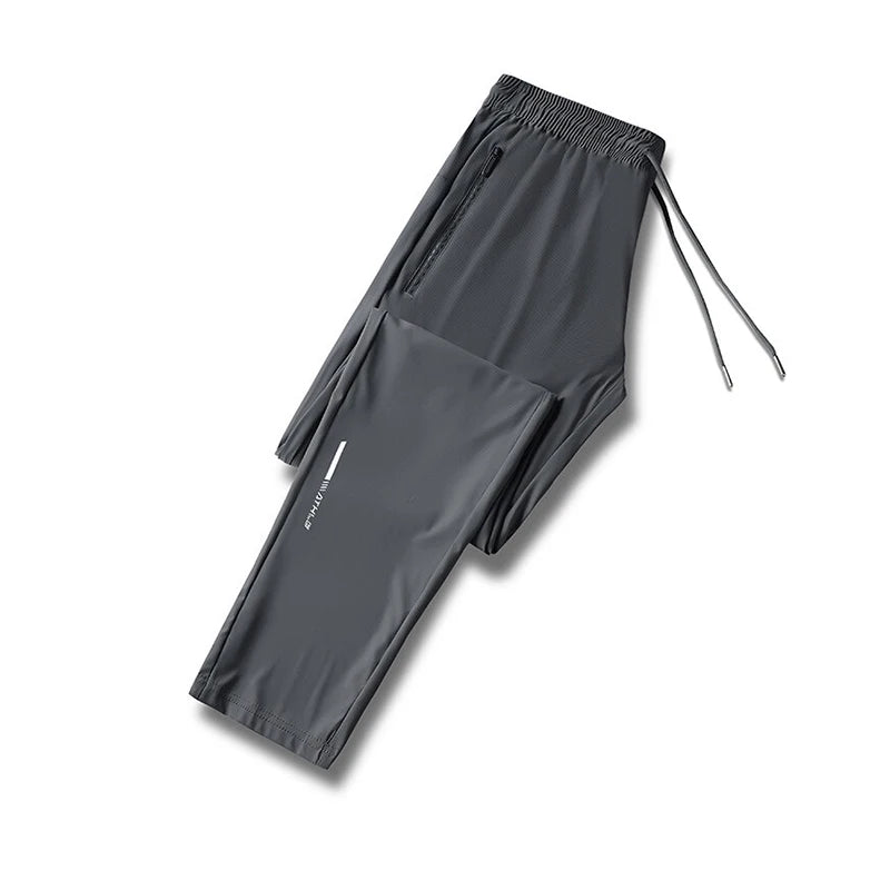 Gray men's ice silk performance pants laid flat with drawstring visible