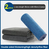 Two blue microfiber cleaning towels are shown next to a stack of gray ones.